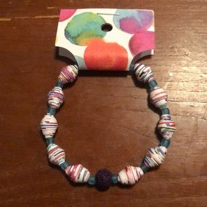 A bracelet with handmade hardened paper beads by me full of fun colors